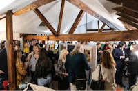 a group of people standing around in a barn